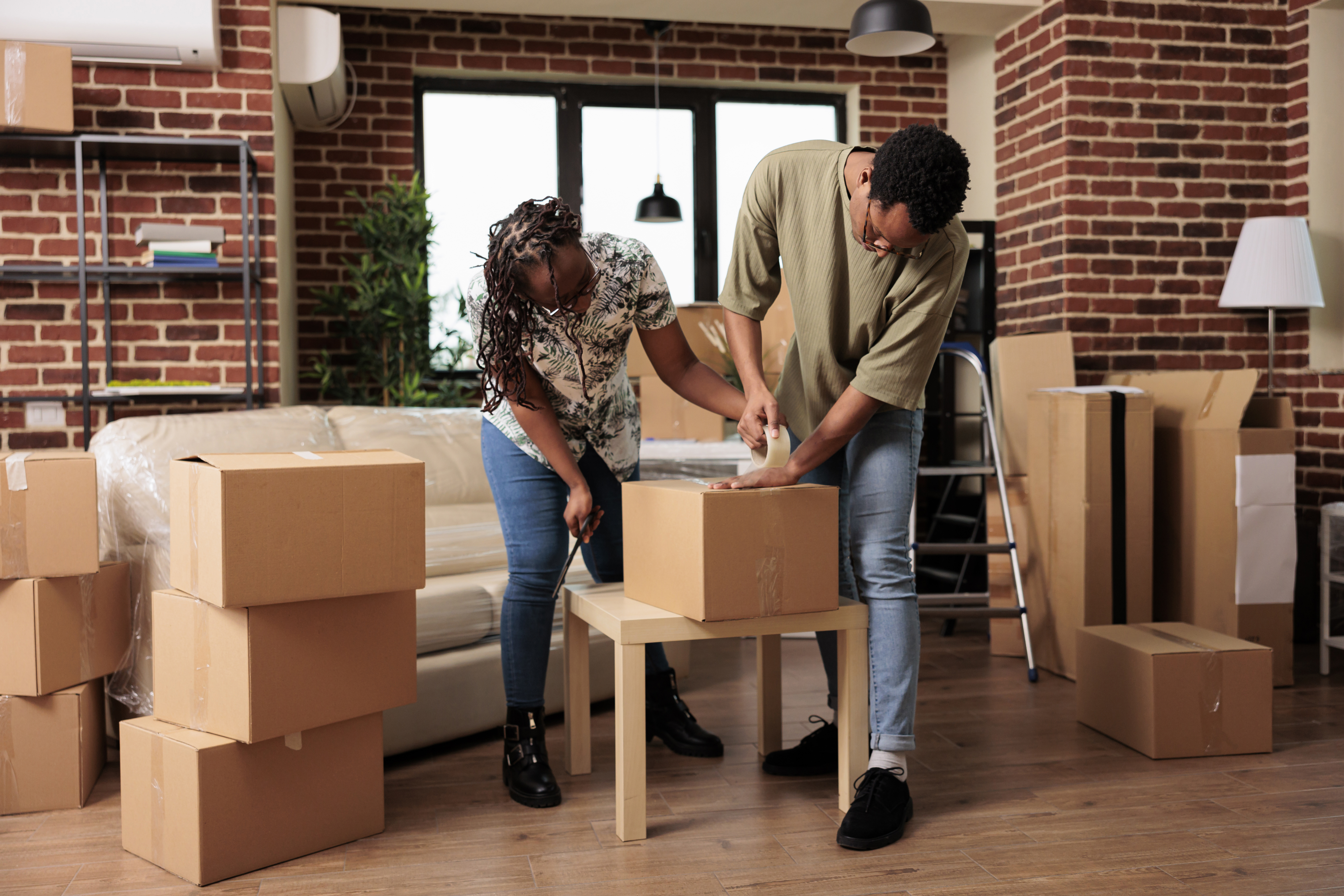 Married homeowners preparing furniture for transportation